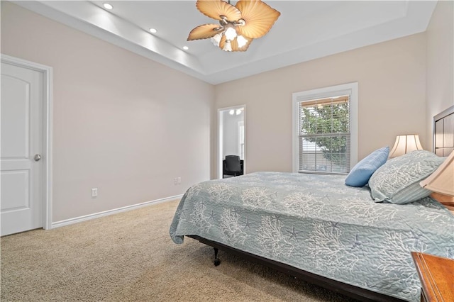 bedroom featuring carpet floors, recessed lighting, a raised ceiling, a ceiling fan, and baseboards