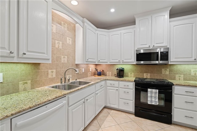 kitchen featuring white cabinets, dishwasher, stainless steel microwave, black electric range oven, and a sink