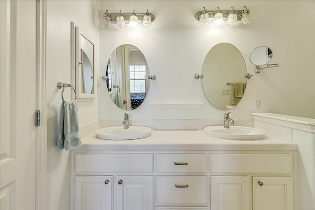 full bath featuring double vanity and a sink