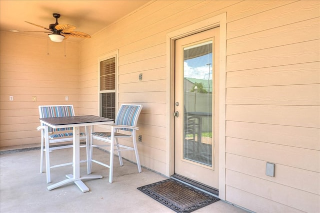 doorway to property with a ceiling fan, outdoor dining area, and a patio