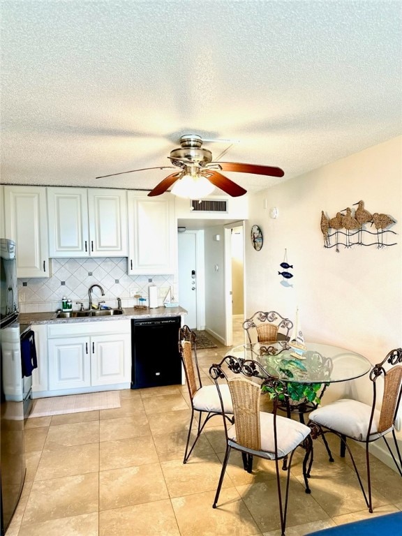 kitchen with white cabinetry, sink, a textured ceiling, backsplash, and black dishwasher