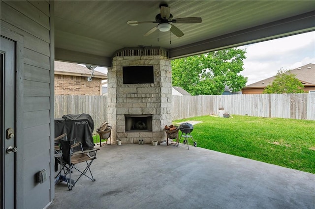 1116 Santa Catalina St, Portland, TX 78374 - view of patio / terrace with a fenced backyard, ceiling fan, an outdoor stone fireplace, and area for grilling