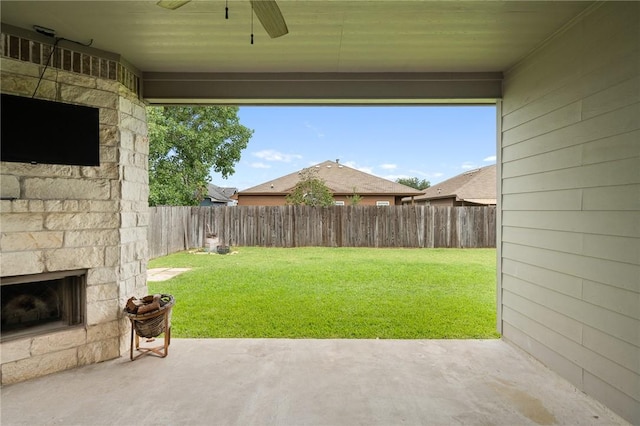 1116 Santa Catalina St, Portland, TX 78374 - fenced backyard featuring an outdoor stone fireplace, a ceiling fan, and a patio area
