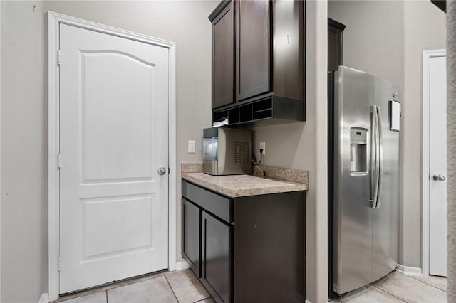 1116 Santa Catalina St, Portland, TX 78374 - kitchen with baseboards, light countertops, dark brown cabinets, light tile patterned flooring, and stainless steel refrigerator with ice dispenser
