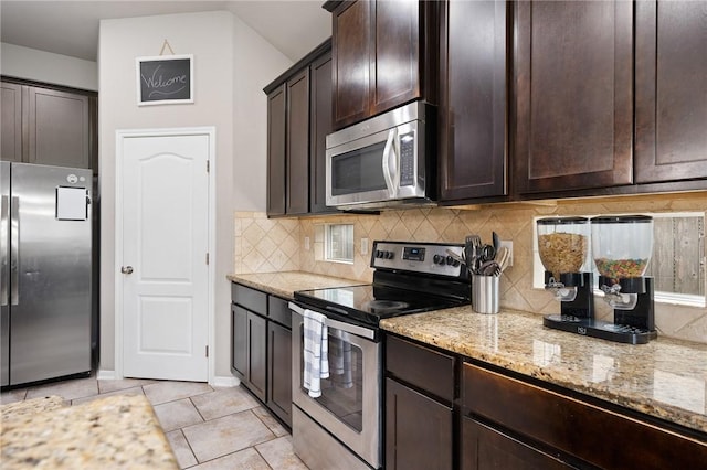 1116 Santa Catalina St, Portland, TX 78374 - kitchen with backsplash, appliances with stainless steel finishes, light stone counters, and dark brown cabinetry