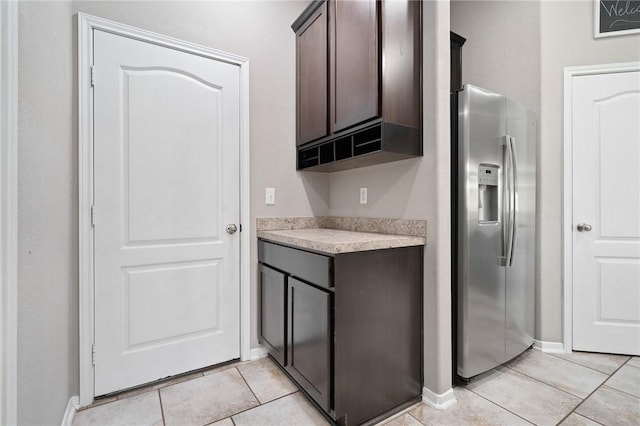 1116 Santa Catalina St, Portland, TX 78374 - kitchen with stainless steel fridge with ice dispenser, dark brown cabinetry, light countertops, and light tile patterned floors