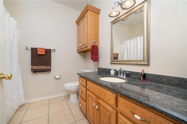 bathroom featuring toilet, vanity, and tile patterned floors