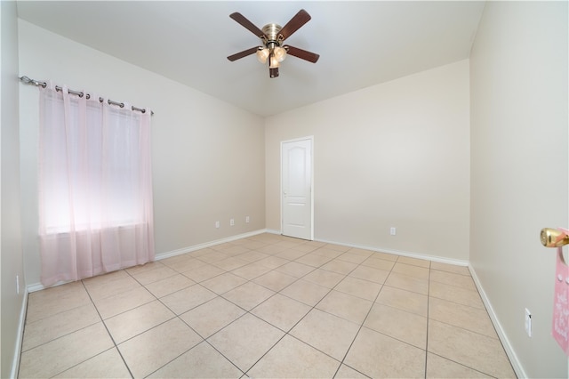 spare room with light tile patterned floors and ceiling fan