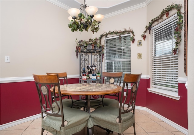 dining room with ornamental molding, light tile patterned floors, and an inviting chandelier