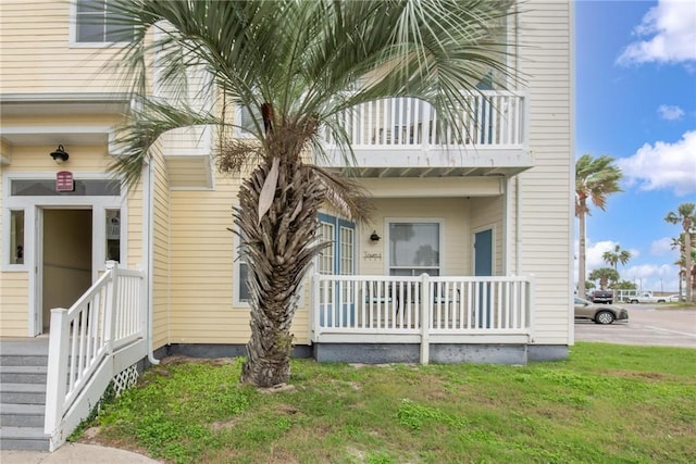 entrance to property featuring a lawn