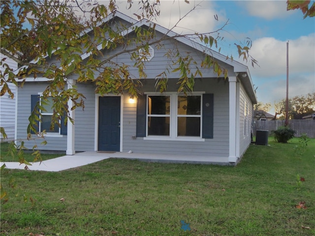 exterior space with central AC unit and a yard