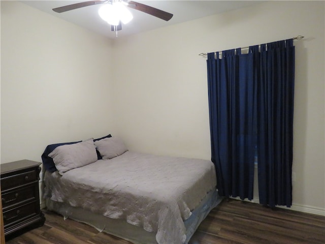 bedroom featuring dark hardwood / wood-style flooring and ceiling fan