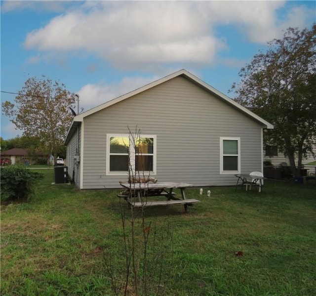 2735 Beaumont Ave, Ingleside, TX 78362 - back of house with a yard and cooling unit