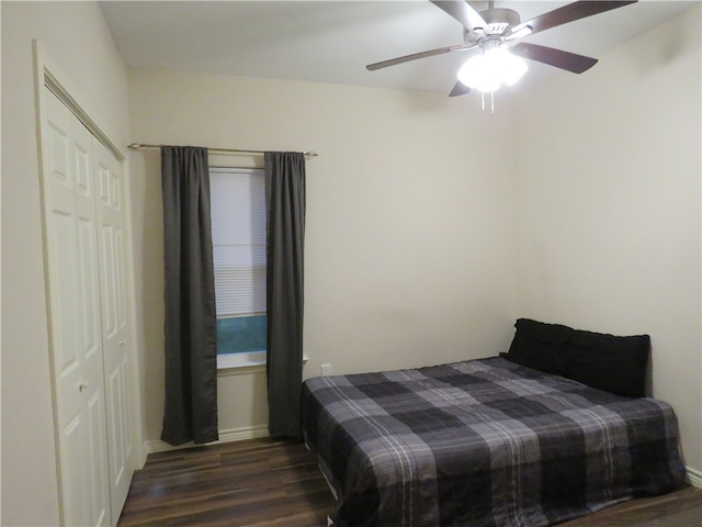 bedroom with a closet, ceiling fan, and dark hardwood / wood-style floors