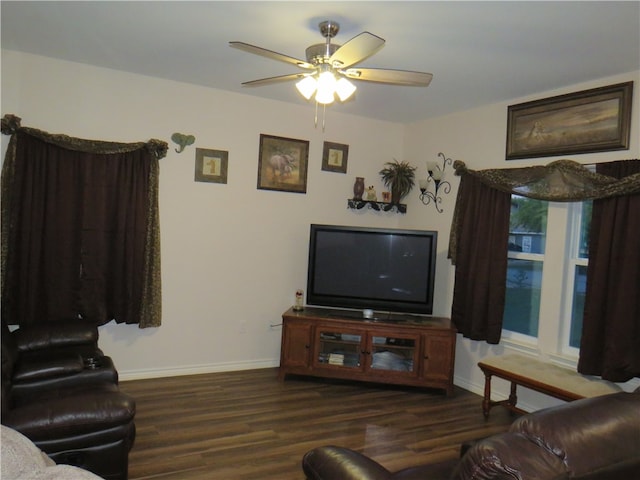 living room with dark hardwood / wood-style flooring and ceiling fan