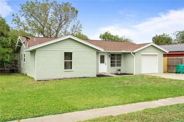 ranch-style home featuring a garage and a front lawn