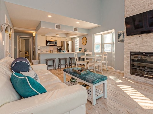 living room with a fireplace and light hardwood / wood-style flooring