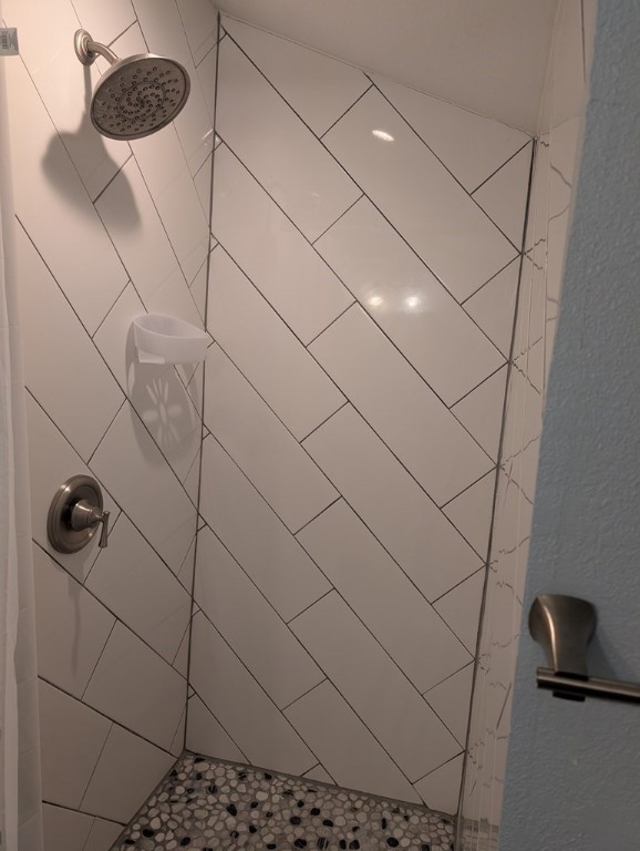 bathroom with tiled shower