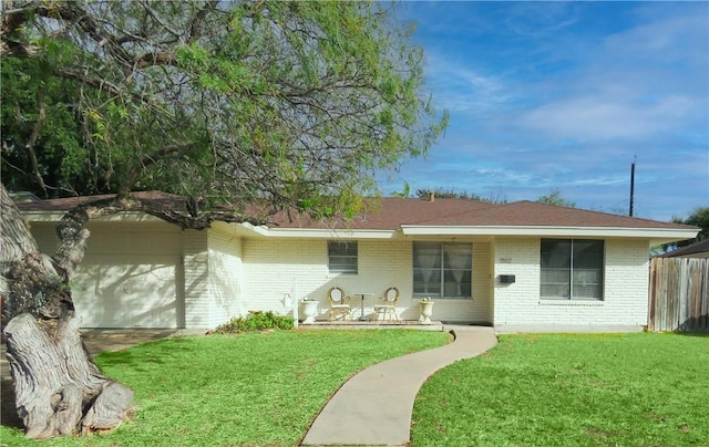 back of property featuring a yard and a garage