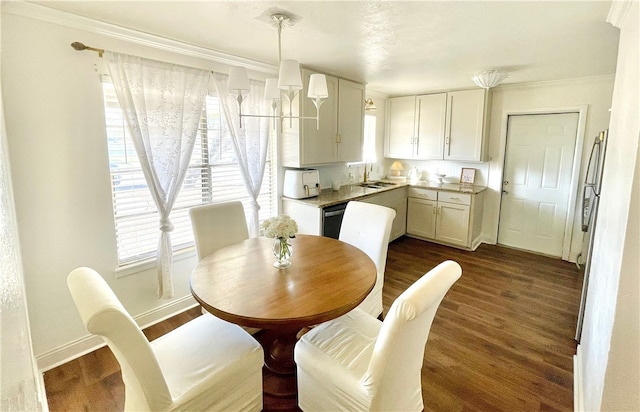 dining room with crown molding, sink, and dark wood-type flooring