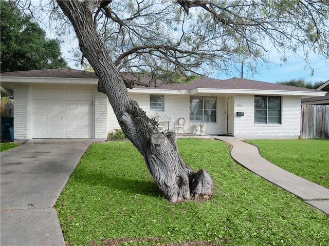 single story home with a front yard and a garage