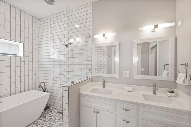 bathroom with a freestanding tub, a walk in shower, double vanity, and tile walls