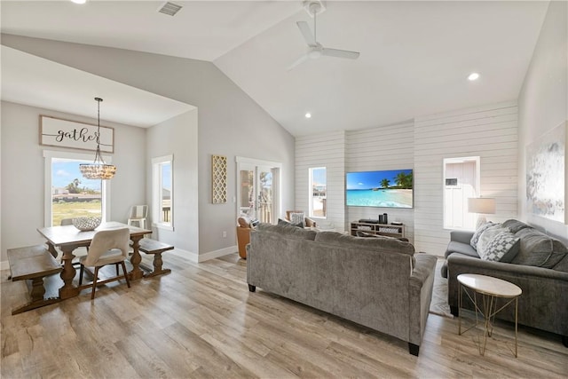 living room with a chandelier, ceiling fan, light wood-style floors, baseboards, and recessed lighting