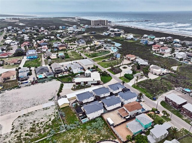 aerial view of property's location with a nearby body of water and nearby suburban area