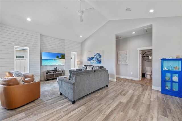 living area with a ceiling fan, lofted ceiling, light wood-type flooring, baseboards, and recessed lighting