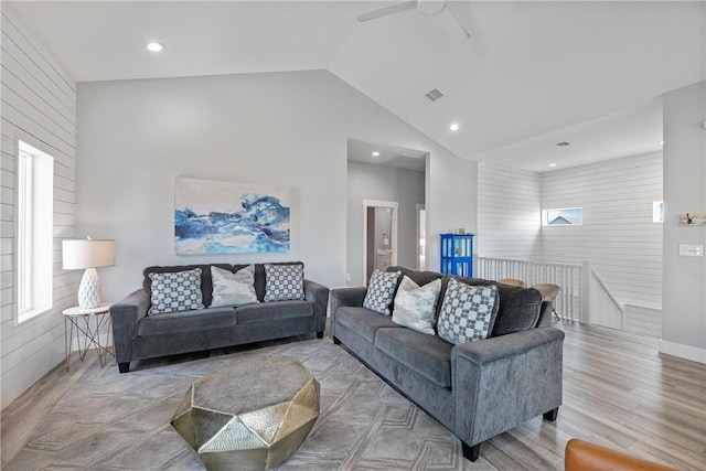 living area featuring wood finished floors, lofted ceiling, ceiling fan, baseboards, and recessed lighting