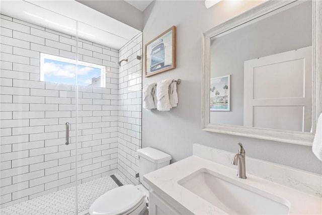 full bath featuring toilet, a stall shower, and vanity