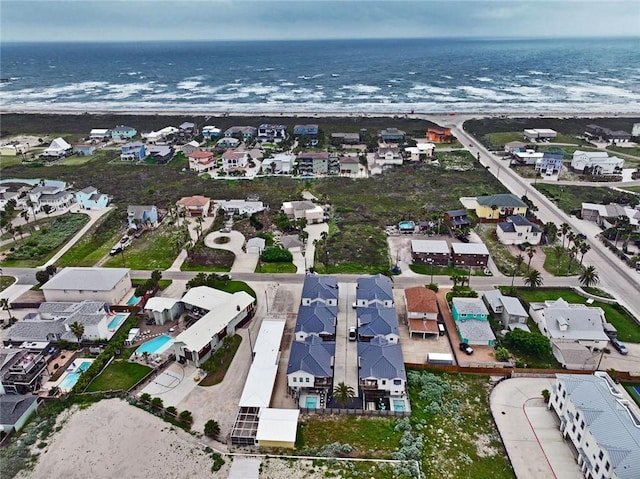 aerial view of property's location with nearby suburban area and a large body of water