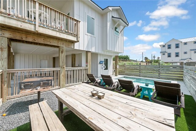 wooden deck with a fenced backyard
