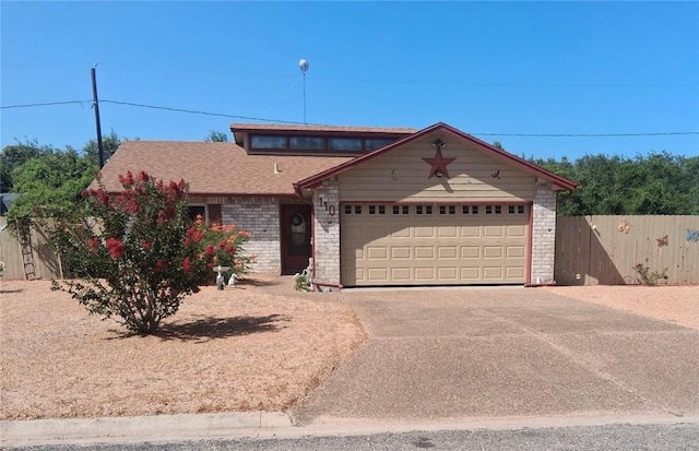 110 Spoonbill Ave, Aransas Pass, TX 78336 - view of front facade with concrete driveway, a garage, and brick siding
