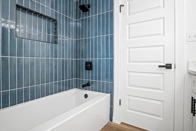 bathroom featuring shower / tub combination, wood finished floors, and vanity