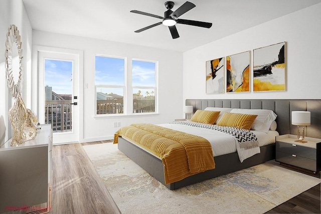 bedroom featuring wood finished floors, access to exterior, and a ceiling fan