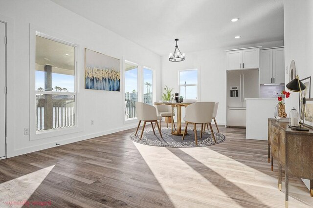 bedroom featuring baseboards, visible vents, wood finished floors, and recessed lighting