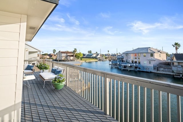 balcony featuring a residential view and a water view