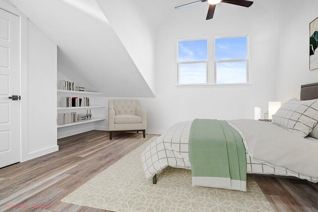 bedroom featuring lofted ceiling, ceiling fan, baseboards, and wood finished floors