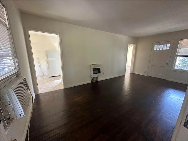 interior space featuring dark hardwood / wood-style flooring and heating unit