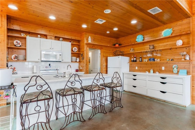 kitchen featuring visible vents, open shelves, a sink, finished concrete floors, and white appliances