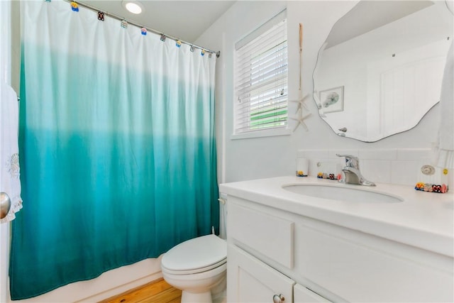 full bathroom with toilet and vanity