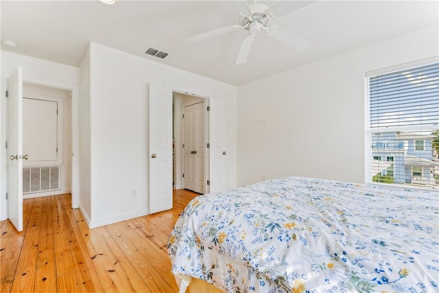 bedroom with visible vents, a ceiling fan, and light wood finished floors