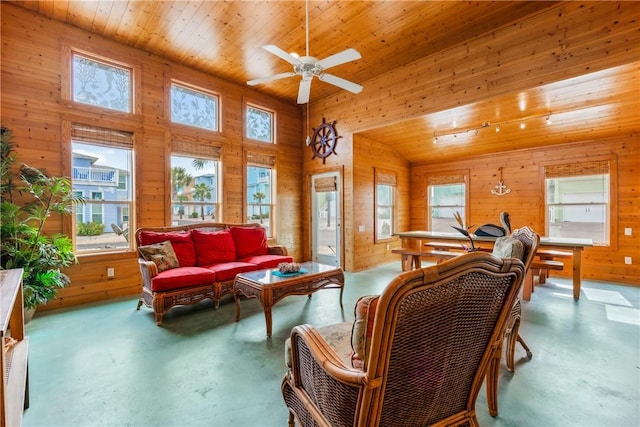 interior space with wooden ceiling, a healthy amount of sunlight, wood walls, and finished concrete floors