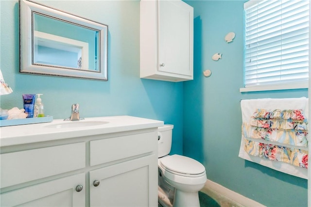 half bathroom featuring vanity and toilet