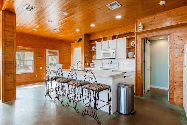 kitchen featuring wooden walls, visible vents, finished concrete floors, white appliances, and open shelves