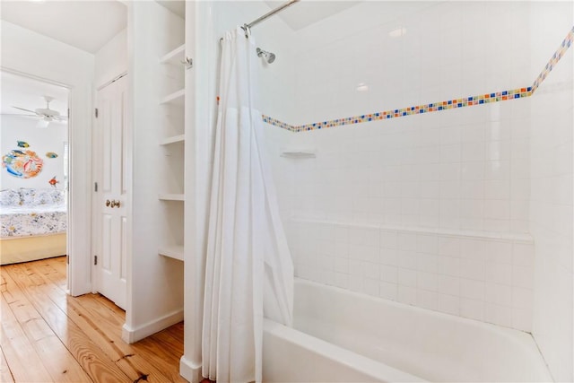 bathroom with connected bathroom, shower / tub combo, a ceiling fan, and wood finished floors