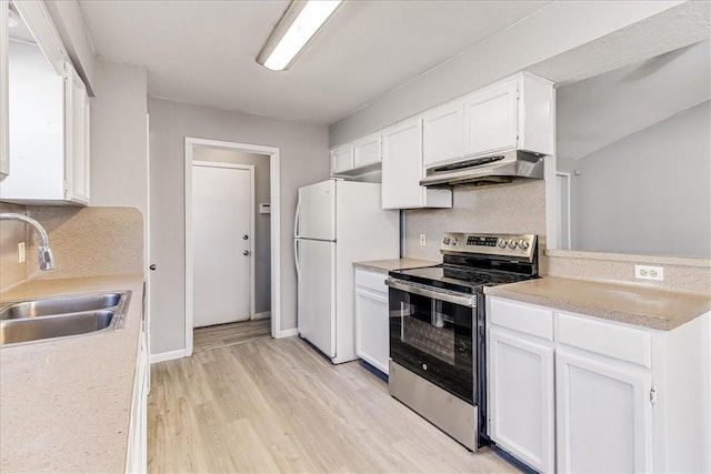 6701 Meadowbreeze Pkwy, Corpus Christi, TX 78414 - kitchen with stainless steel electric stove, under cabinet range hood, a sink, and white cabinets