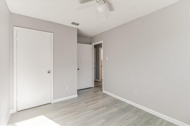 6701 Meadowbreeze Pkwy, Corpus Christi, TX 78414 - unfurnished bedroom with light wood-style flooring, baseboards, and ceiling fan