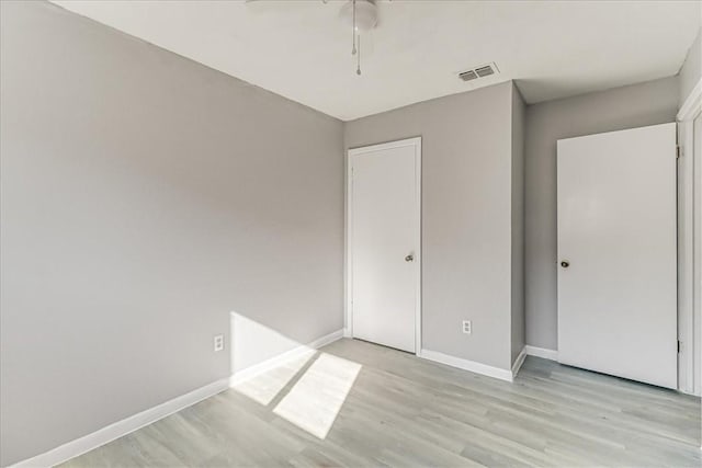6701 Meadowbreeze Pkwy, Corpus Christi, TX 78414 - unfurnished bedroom featuring light wood-type flooring, baseboards, and a ceiling fan